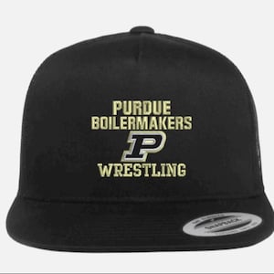 May include: Black snapback cap with the text "PURDUE BOILERMAKERS WRESTLING" in gold lettering. The cap has a mesh back and a flat peak. The Purdue "P" logo is in the centre.