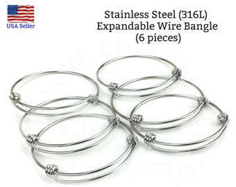 May include: Six silver expandable wire bangles made of stainless steel (316L).