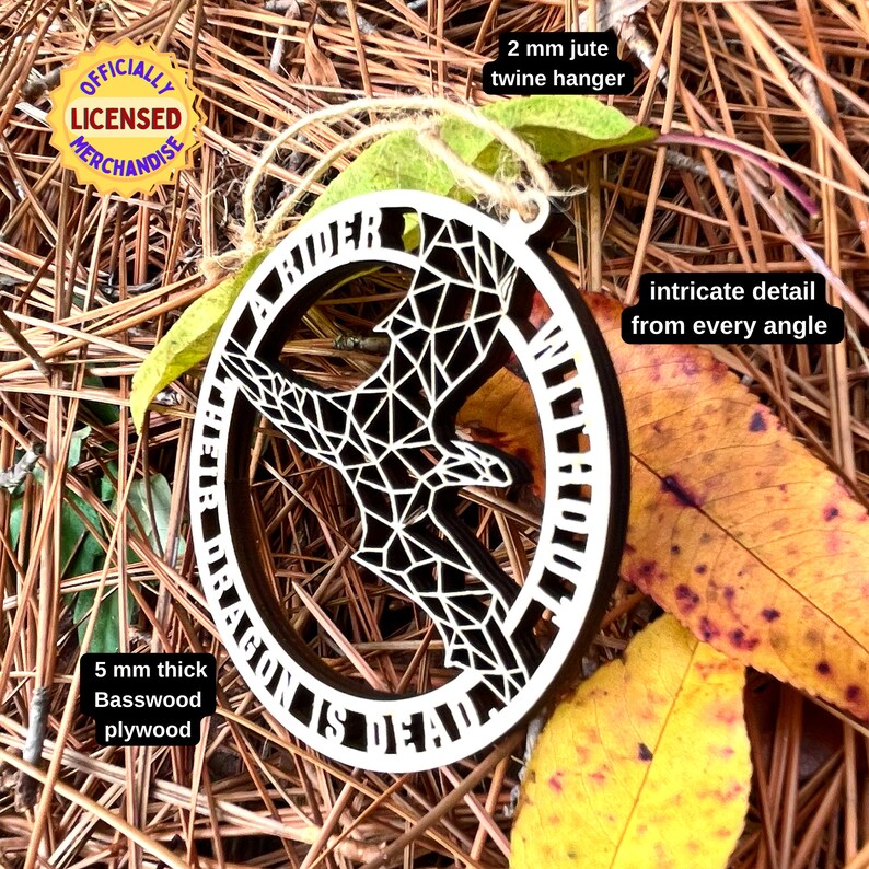 geometric dragon laser cut wood ornament amid fall leaves to show it can be used year round