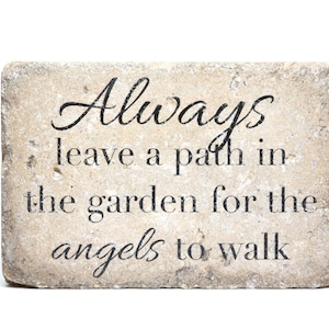 May include: A stone garden plaque with the text "Always leave a path in the garden for the angels to walk".