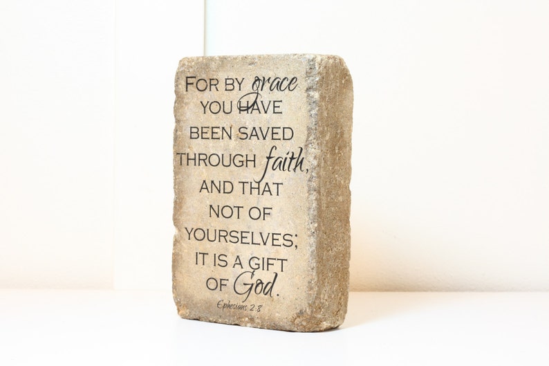 May include: A stone block with the text "FOR BY grace YOU HAVE BEEN SAVED THROUGH faith, AND THAT NOT OF YOURSELVES; IT IS A GIFT OF God. Ephesians 2:8"