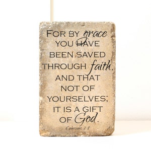 May include: A stone coaster with the Bible verse "For by grace you have been saved through faith, and that not of yourselves; it is a gift of God." Ephesians 2:8.
