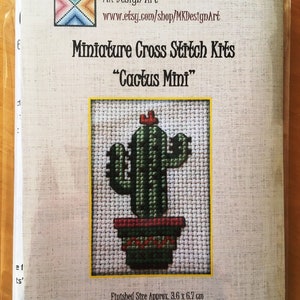 May include: A cross stitch kit for a miniature cactus in a pot. The kit includes all the materials needed to create a finished piece that is approximately 3.6 cm by 6.7 cm. The kit is titled "Cactus Mini" and is from MK Design Art.