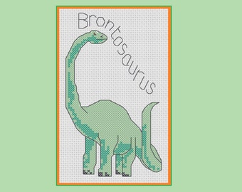 May include: Cross-stitch artwork of a green Brontosaurus dinosaur with the word "Brontosaurus" above it. The dinosaur has a long neck and tail, with a detailed pattern. The artwork is framed with an orange border on a light green background.