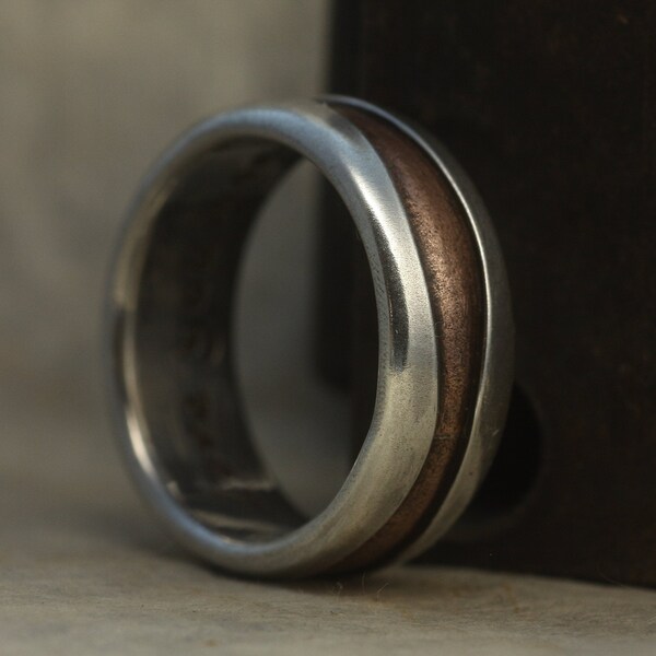 A mans or womans ring of silver and copper, perfect wedding or engagement ring, hammered, and oxidised to give a simple and classic look.