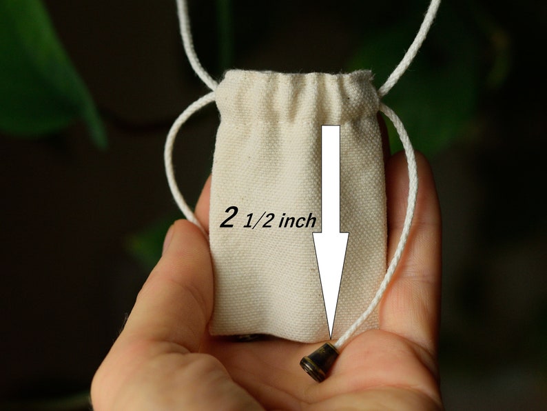 May include: A small white drawstring bag with a 2 1/2 inch diameter. The bag is made of natural cotton fabric and has a simple design.