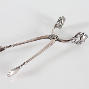 Danish Georg Jensen Art Nouveau Acorn Sterling Silver Cutlery by Johan Rode 1915. Sugar Pliers 9.5 cm. With Stamp From the period 1930-45