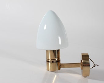 Hans-Agne Jakobsson Wall Sconce Model V220. It's made of Brass with White Opaline Glass Shade. Designed and made in the 1960s