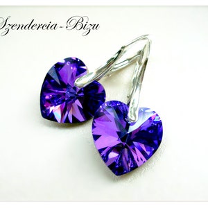 May include: A pair of silver earrings with purple heart-shaped crystals.