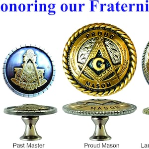 May include: A set of ten decorative cabinet knobs featuring Masonic symbols. The knobs are made of metal and have a silver finish. The symbols include a square and compass, a Shriner emblem, a Texas Mason logo, a Past Master symbol, a Proud Mason logo, a large Texas Mason logo, a small Texas Mason logo, and an Eastern Star emblem. The knobs are all 1 3/4 inches in diameter.