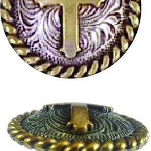 May include: A gold and silver cross-shaped cabinet knob with a rope-like design around the edge.