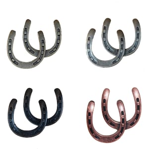 May include: Four pairs of horseshoes in silver, grey, black, and copper finishes. Each horseshoe has a U-shape with nail holes, suitable for rustic decor or equestrian crafts. Ideal for country-themed projects.