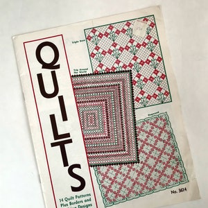 May include: A vintage book titled "QUILTS" with a cover featuring three quilt patterns: "Triple Rose", "Trip Around the World", and "Dogwood". The book includes 14 quilt patterns, plus borders and quilting designs. The book is numbered 3614.