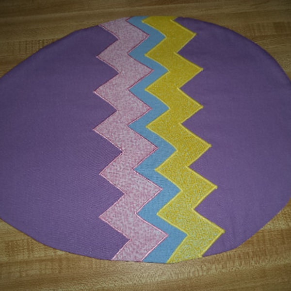 Easter egg shaped set of placemats with appliqued zigzag stripes in pastel colors