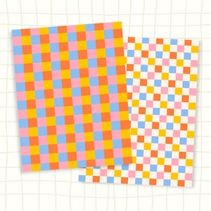 May include: Two rectangular sheets of paper featuring a repeating checkered pattern. The grid consists of alternating squares in bright shades of pink, orange, yellow, and light blue, arranged in a consistent, uniform geometric layout.