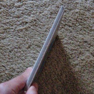 May include: A close-up of the edge of a white book with a slightly textured cover.