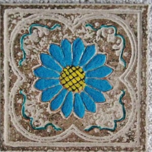 May include: A blue and yellow flower with a white background. The flower is surrounded by a decorative border.