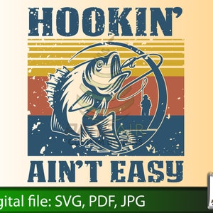 May include: A vintage-style graphic with a distressed background featuring a fish on a hook with the text "HOOKIN' AINT' EASY".