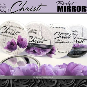 May include: Three round pocket mirrors with a white background and purple flowers. The mirrors feature the text "I can do all things through Christ which strengtheneth me. Philippians 4:13".