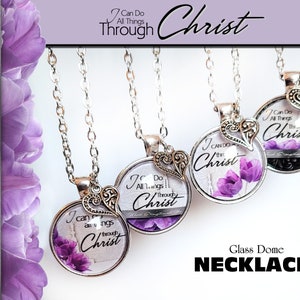 May include: Four silver necklaces with glass dome pendants featuring a purple flower design and the text "I Can Do All Things Through Christ".