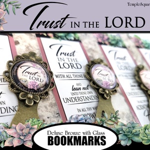 May include: Set of six bronze bookmarks with glass accents. Each bookmark features a floral design and the text "Trust in the Lord". The bookmarks are decorated with succulents.