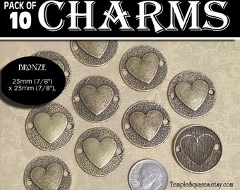 May include: A pack of 10 bronze charms. Each charm is round with a heart in the center and measures 7/8 inches in diameter. The charms have a textured border and two small holes for attaching to other items. The text "PACK OF 10 CHARMS" is at the top.