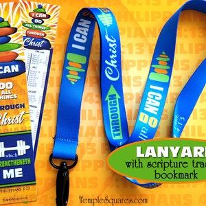 May include: Blue lanyard with the text "I can do all things through Christ" and a stack of colorful stones. The lanyard is paired with a blue and yellow bookmark with the same text and a scripture tracking section. The bookmark also has a dumbbell graphic and the text "which strengtheneth me".