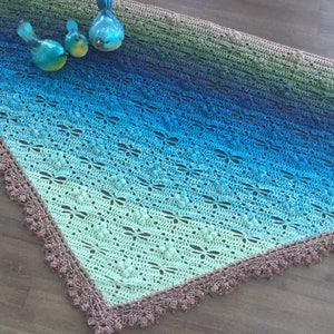 Triangle shape shawl, made from fingering weigh yarn with dragonflies,, lace edge border.