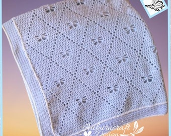 May include: A light blue crocheted baby blanket with a delicate butterfly pattern. The blanket has a white border.