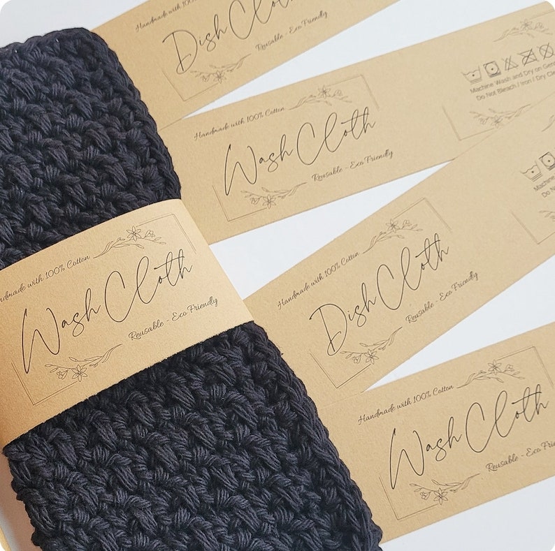 May include: Black crocheted washcloth with a brown paper label that reads "Handmade with 100% Cotton Wash Cloth Reusable - Eco Friendly".