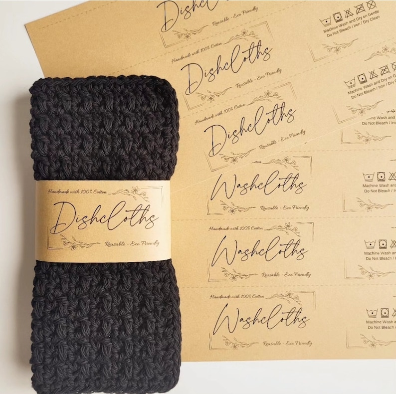May include: A black crocheted dishcloth with a brown paper label that reads "Handmade with 100% Cotton - Dishcloths - Reusable - Eco Friendly".