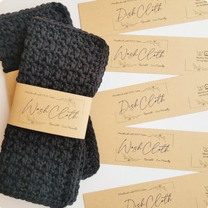 May include: Two black crocheted washcloths with brown paper tags that say "Handmade with 100% Cotton Wash Cloth Reusable Eco Friendly" and "Handmade with 100% Cotton Dish Cloth Reusable Eco Friendly".