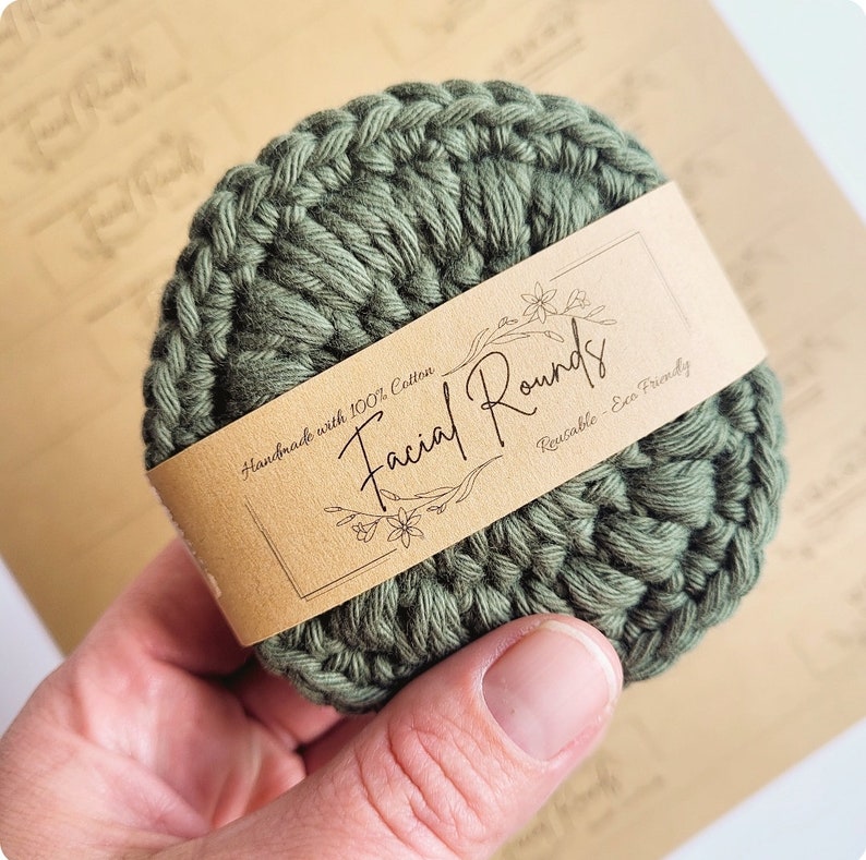 May include: A green crocheted facial round with a brown paper label that reads "Facial Rounds Handmade with 100% Cotton Reusable - Eco Friendly".