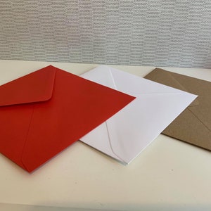 May include: Three square envelopes arranged in a row, featuring one vibrant red envelope, one crisp white envelope, and one natural brown kraft paper envelope. Each envelope is closed with a triangular flap pointing towards the centre.