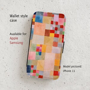 May include: A colorful phone case with a geometric pattern of squares in shades of red, yellow, blue, green, and pink. The case is a wallet style and is available for Apple and Samsung phones. The model pictured is an iPhone 11.