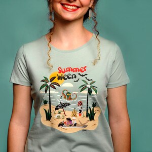 May include: A light blue t-shirt featuring a graphic print of a beach scene with palm trees, an octopus, and the text "Summer Ween".