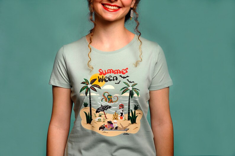 May include: A light blue t-shirt featuring a graphic print of a beach scene with palm trees, an octopus, and the text "Summer Ween".