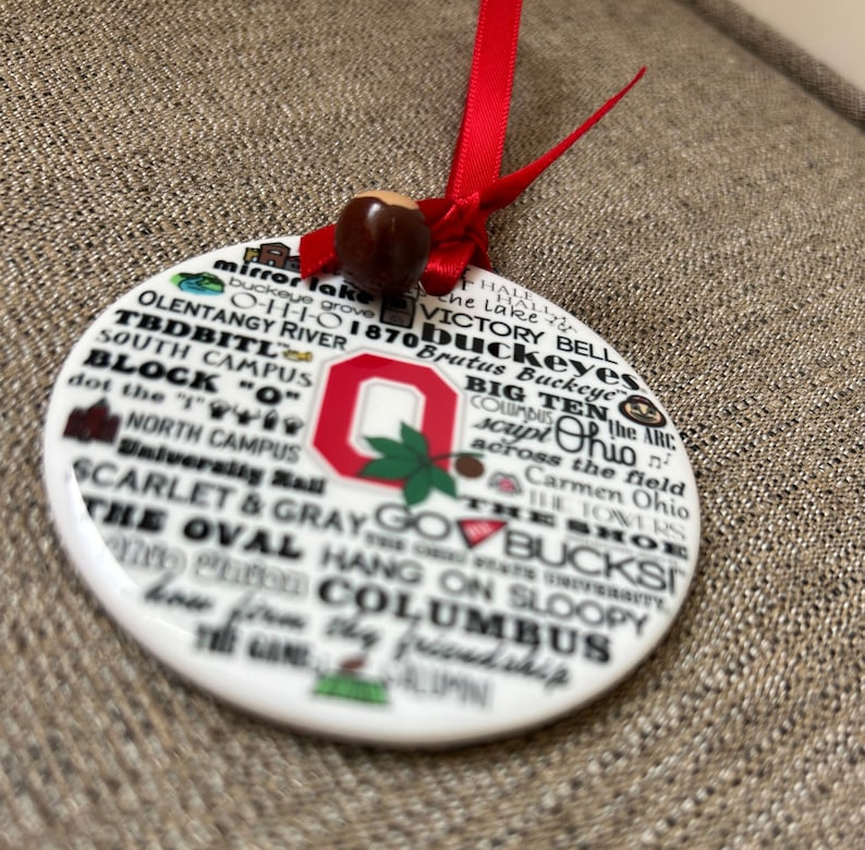 handcrafted buckeye charm dangles on the front of each ornament