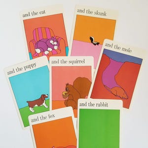A set of 7 vintage rectangular cards with colourful illustrations of animals with black text across the top. The text on the cards reads 'and the cat', 'and the fox', 'and the mole', 'and the puppy', 'and the rabbit', 'and the skunk', 'and the squirrel'. The cartoon style illustrations have a white border around the edges.