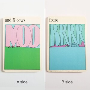 an image showing both sides of the same rectangular card. Side A has an illustration of cows on green grass and the large word MOO in pink against the blue sky and the text 'and 5 cows' at the top. Side B has an illustration of an igloo on a blue background and the text 'froze' at the top.