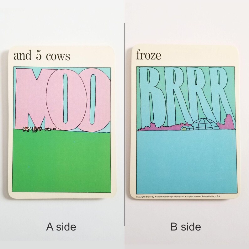 an image showing both sides of the same rectangular card. Side A has an illustration of cows on green grass and the large word MOO in pink against the blue sky and the text 'and 5 cows' at the top. Side B has an illustration of an igloo on a blue background and the text 'froze' at the top.