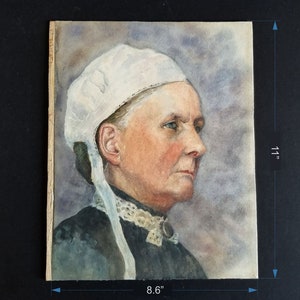 May include: Watercolour painting of a woman wearing a white bonnet and a dark dress. The painting is on paper and measures 8.6 inches by 11 inches.