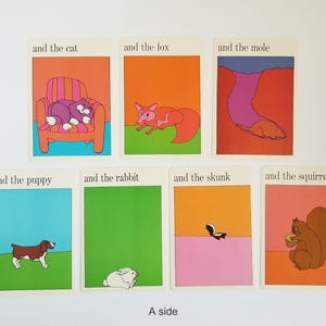 A set of 7 vintage rectangular cards with illustrations of animals and text on both sides. The text on the cards reads 'and the cat', 'and the fox', 'and the mole', 'and the puppy', 'and the rabbit', 'and the skunk', 'and the squirrel'. The cartoon style illustrations are very colourful and have a white border around the edges. The text is in black across the top.