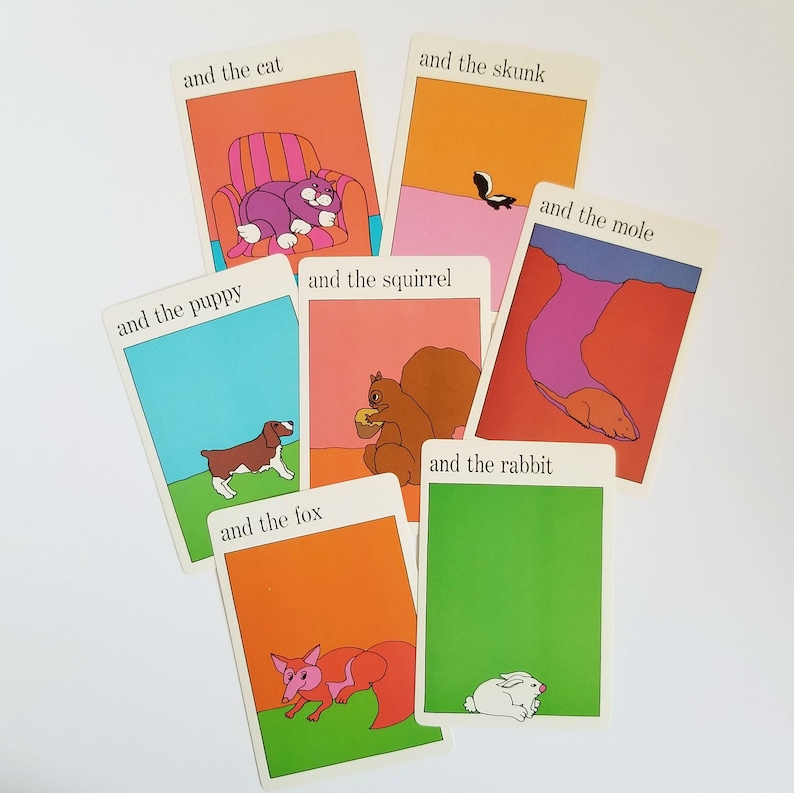 A set of 7 vintage rectangular cards with colourful illustrations of animals with black text across the top. The text on the cards reads 'and the cat', 'and the fox', 'and the mole', 'and the puppy', 'and the rabbit', 'and the skunk', 'and the squirrel'. The cartoon style illustrations have a white border around the edges.