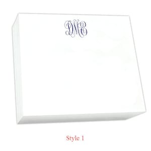 May include: A stack of white notepad paper with a blue monogram "D.M.E." printed on the top sheet. The notepad is labeled "Style 1".