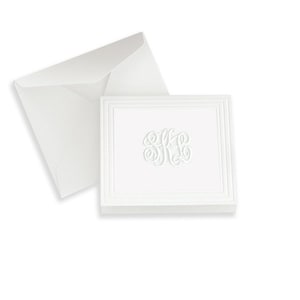 May include: White folded note cards with a white embossed monogram in a white envelope.
