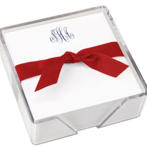 May include: A clear plastic box filled with white note cards with a red ribbon tied around the box. The note cards have a blue monogram on the front.