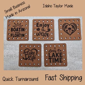 May include: Five square brown coasters with black text and designs. The coasters have phrases like "Boatin and Floatin" and "Enjoy the wave." Each coaster has small holes around the edges. The text "Small Business Made in Arizona!" is also visible.