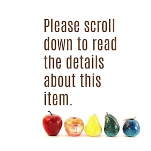 May include: The image displays a collection of decorative fruit sculptures, including a red apple, an orange, a yellow pear, a green pear, and a blue fruit. The text above reads, "Please scroll down to read the details about this item."