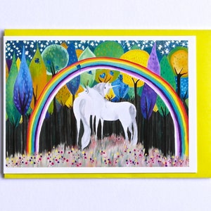 May include: Two white unicorns stand under a rainbow in a forest with colorful trees and a starry night sky.